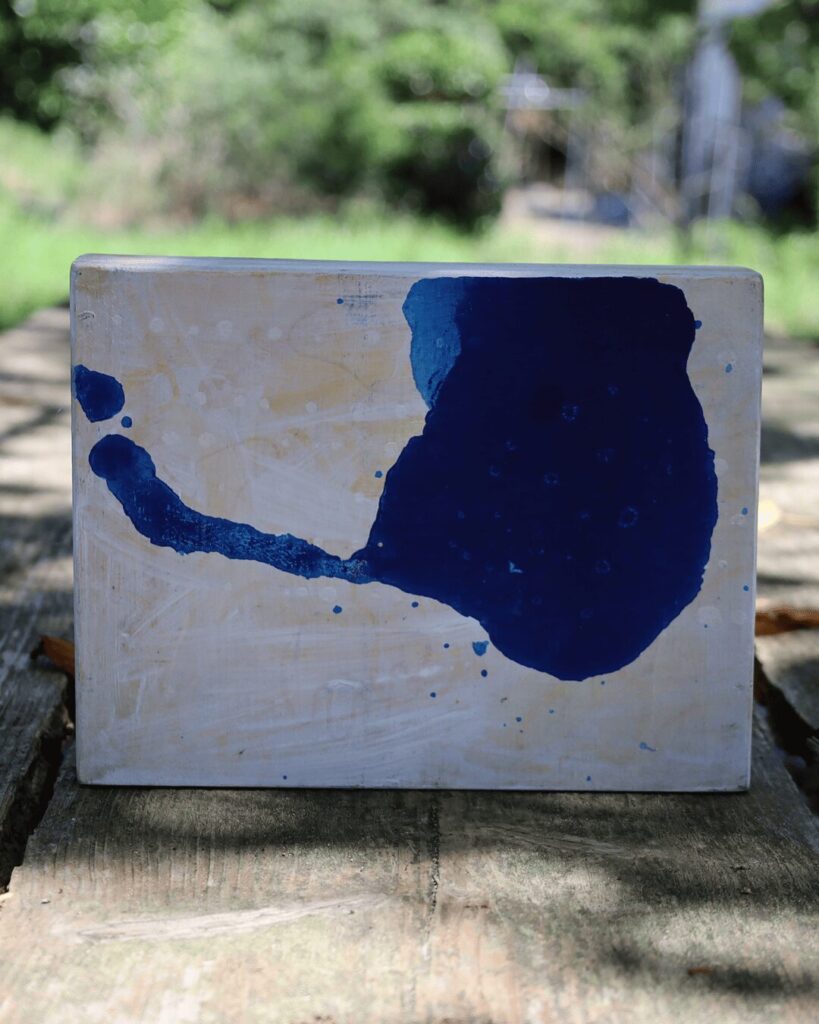 "Objects, No. 13," a serene frontal view of a minimalist abstract art object, presented like a specimen of pure form. The composition is defined by a single, powerful calligraphic gesture in deep blue, creating one singular, organic form that is set against a quiet and textured white background. This piece explores the fundamental relationship between a solid form and the empty space that defines it. This piece of contemporary art is from the 'Objects' series by Asahi Tanaka.