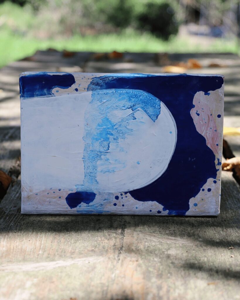 "Objects, No. 11," a striking frontal view of a minimalist abstract art object. The composition is defined by the powerful juxtaposition of a large, luminous white form against a deep navy blue field, creating a sharp, graphic division and a palpable sense of tension. This contemporary artwork is from the 'Objects' series by Asahi Tanaka.