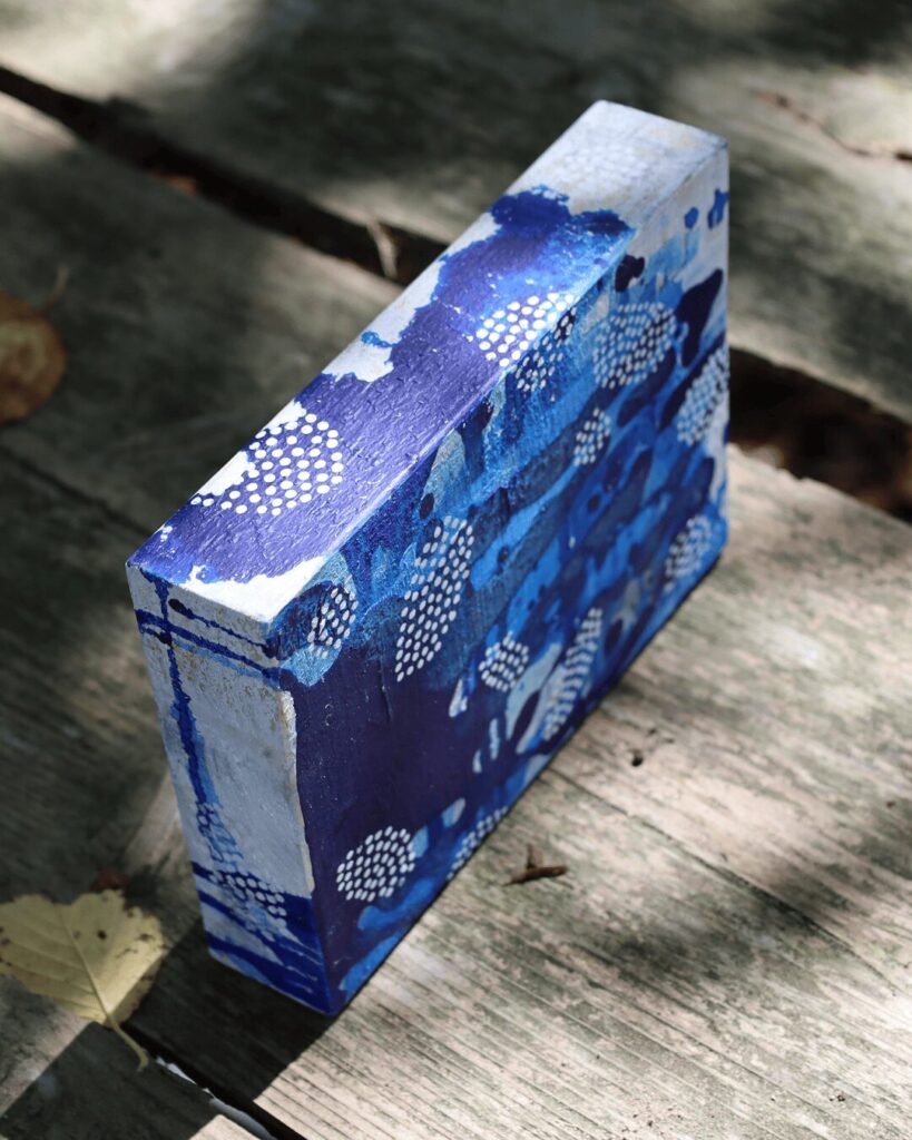 "Objects, No. 2," an angled, three-quarter view of a sculptural abstract art block, highlighting how rhythmic clusters of white dots wrap around the object's form. These precise, decorative patterns create a striking contrast against a fluid, deep blue painted surface. This unique piece is from the 'Objects' series by Asahi Tanaka.