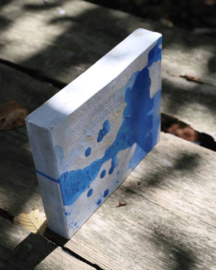 "Objects, No. 8," an angled perspective of a minimalist art object, showcasing the rich, glossy texture of deep blue paint as it pools and flows over the block's edges. This view emphasizes the object's simple, sculptural form and the pure beauty of the raw materials. This Japandi style artwork is from the 'Objects' series by Asahi Tanaka.